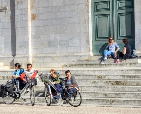persone sedute sui gradini del Duomo a Pietrasanta