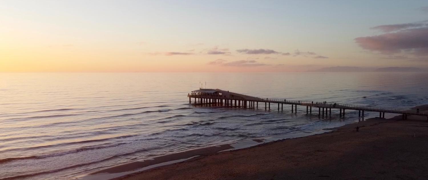 Fotografia aerea con drone della spiaggia e del pontile di Lido di Camaiore al tramonto